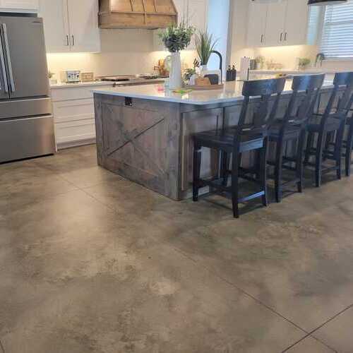 a kitchen with a concrete stained floor