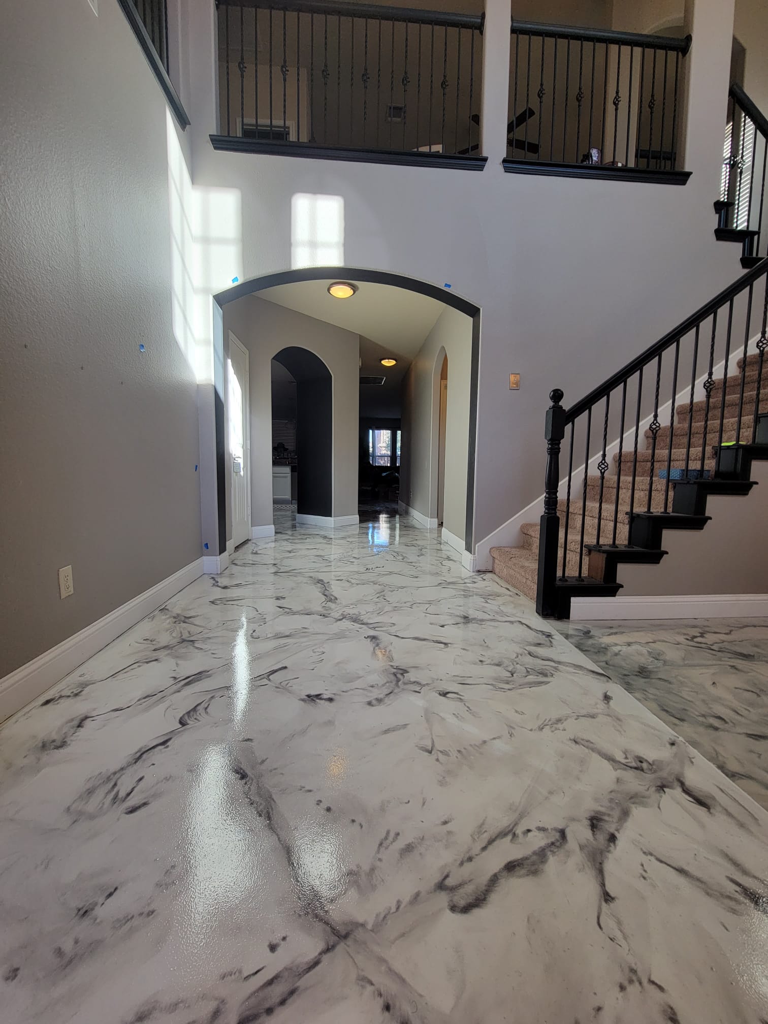 a home with white and black liquid marble flooring